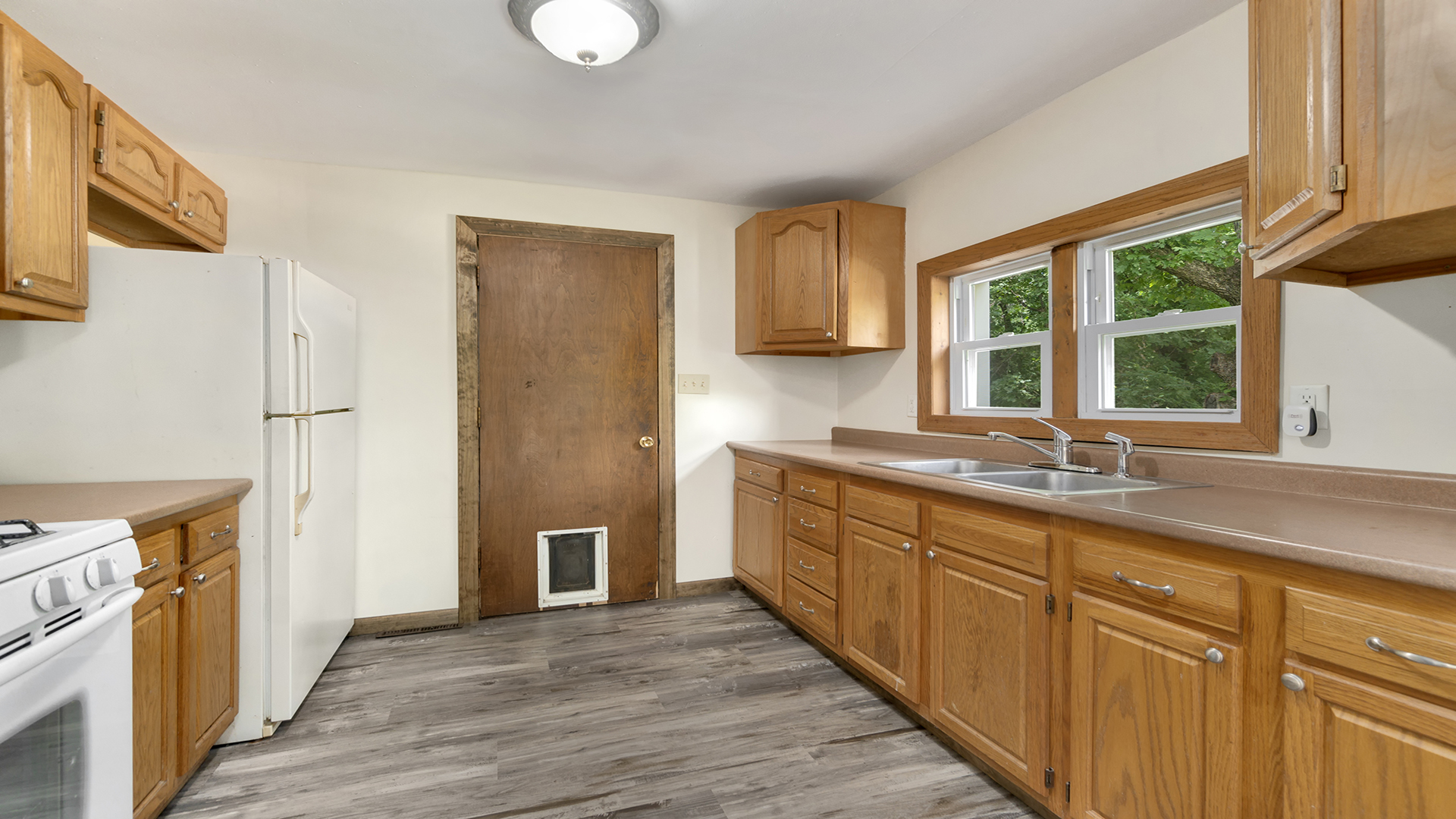 503 West Devils Backbone Road Oregon, IL 61061 - Photo 18 of 46 a kitchen with stainless steel appliances granite countertop a refrigerator a sink dishwasher and wooden cabinets with wooden floor