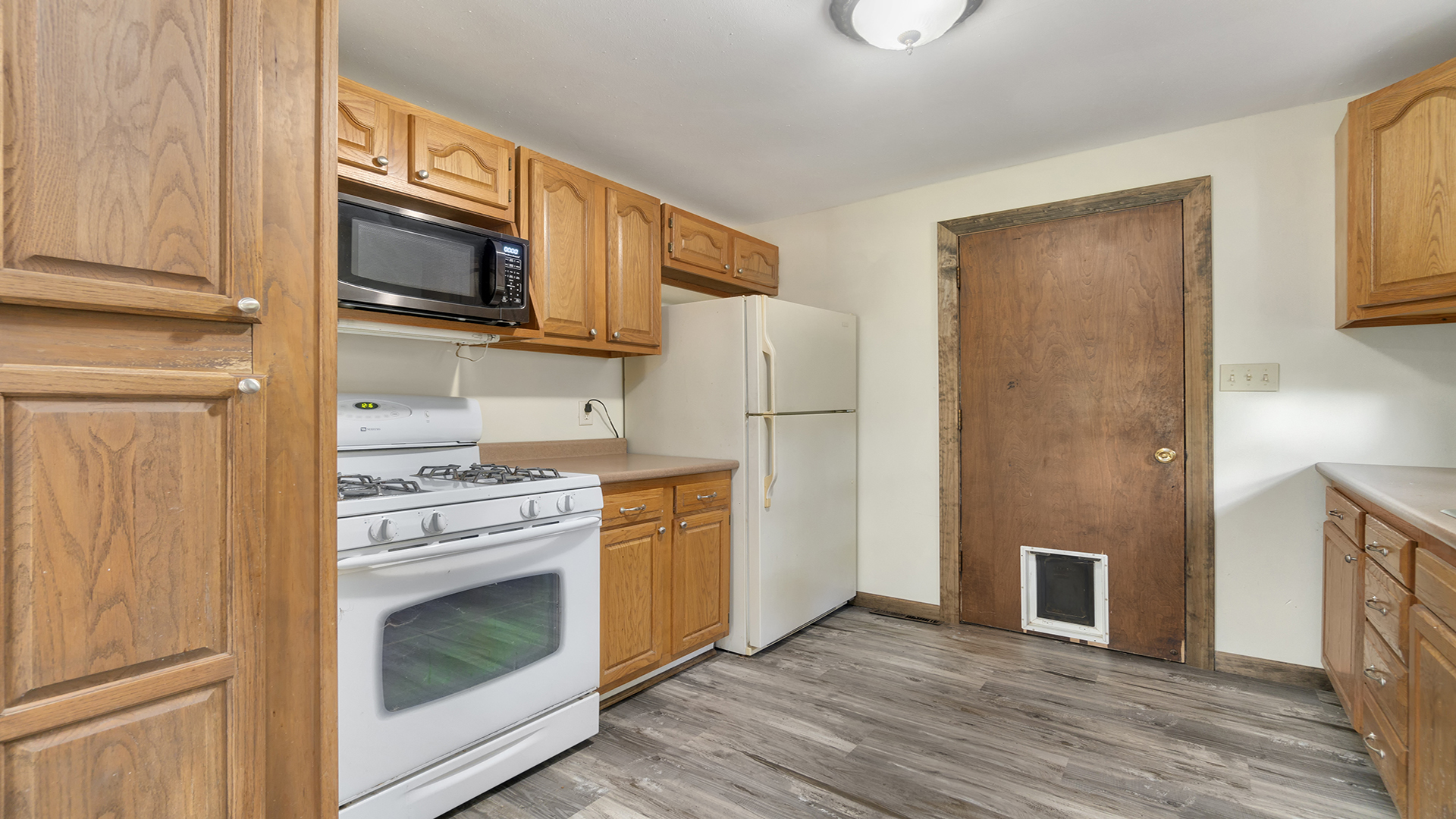 503 West Devils Backbone Road Oregon, IL 61061 - Photo 19 of 46 a kitchen with stainless steel appliances granite countertop a stove top oven microwave and refrigerator