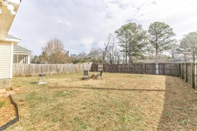 a view of yard with wooden fence
