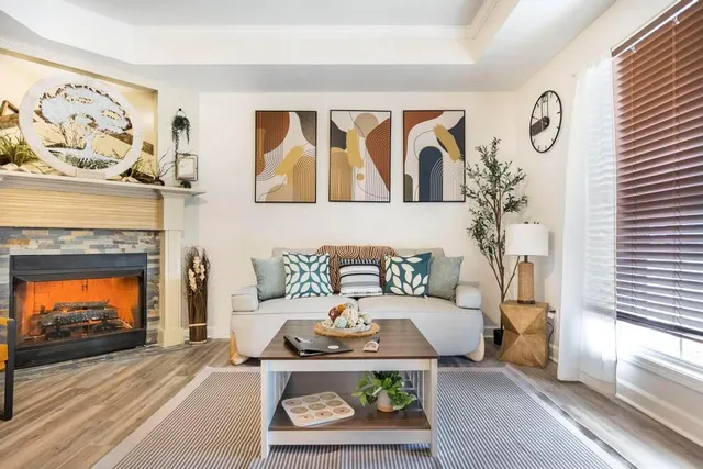 a living room with furniture and a fireplace