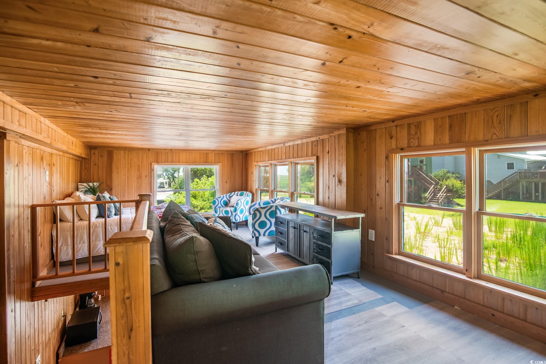 127 Brown Pelican Loop Pawleys Island, SC 29585 - Photo 13 of 31 Living room featuring wooden ceiling and wood walls