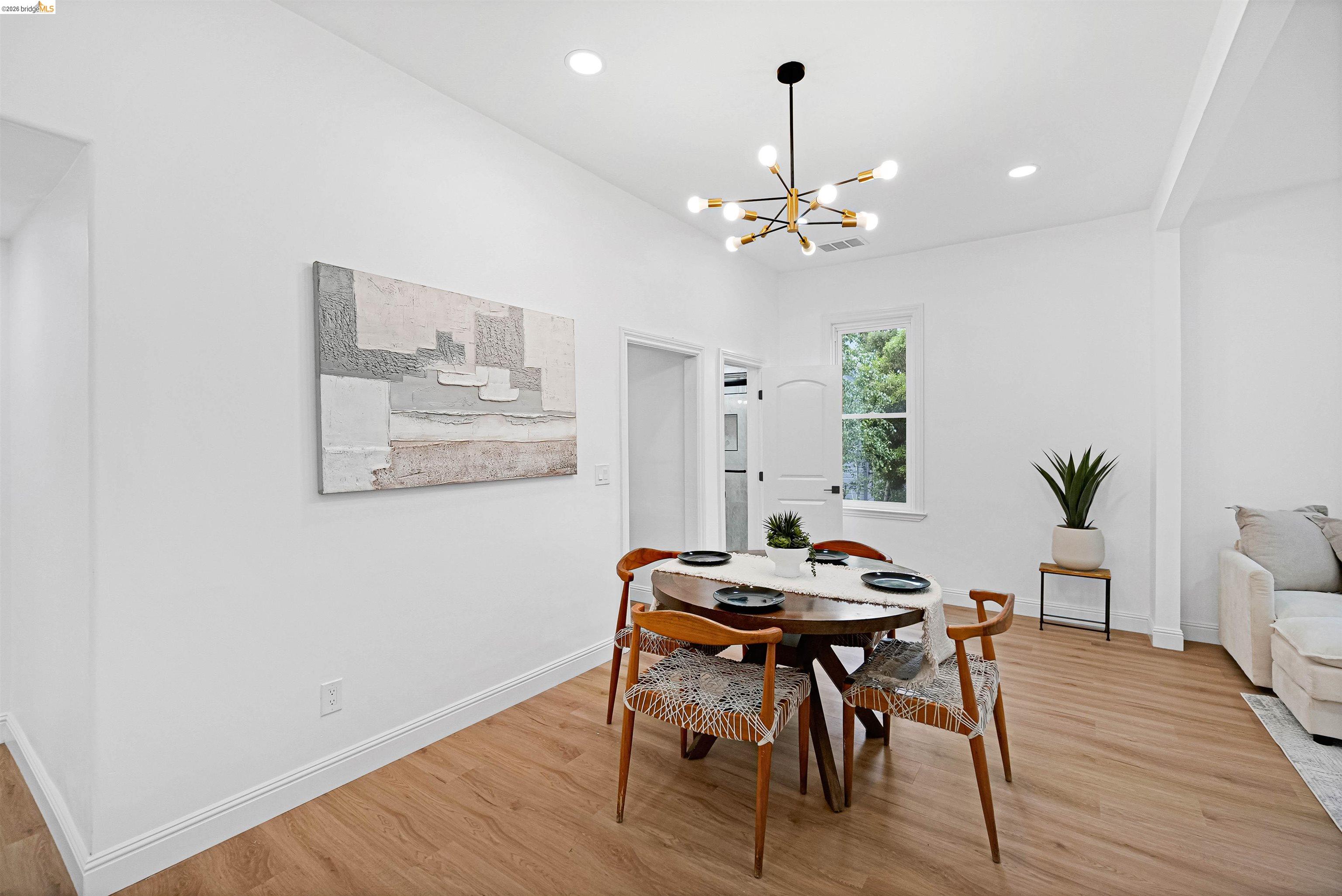 1812 Woolsey Street Berkeley, CA 94703 - Photo 8 of 48 Dining area featuring light wood-finish flooring, recessed lighting, and a modern sputnik-style chandelier