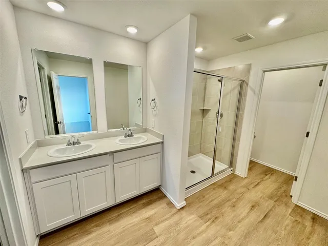 a bathroom with a double vanity sink and a mirror