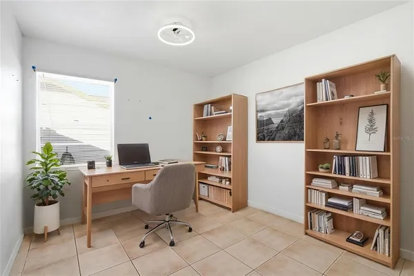 a view of a workspace with furniture and a potted plant