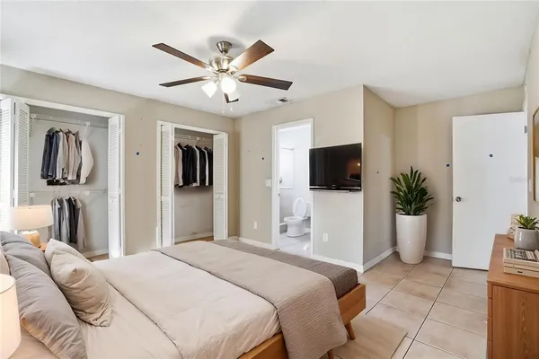 a bedroom with a large bed and a tv