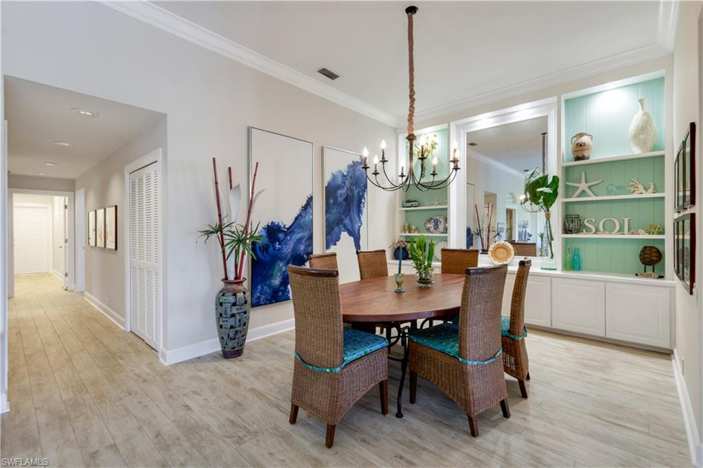 11831 Quail Village Way Naples, FL 34119 - Photo 14 of 32 a view of a dining room with furniture and a chandelier