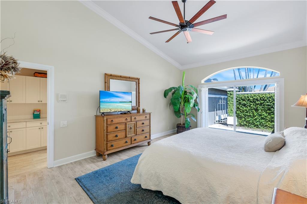 11831 Quail Village Way Naples, FL 34119 - Photo 16 of 32 a bedroom with a bed dresser and a window