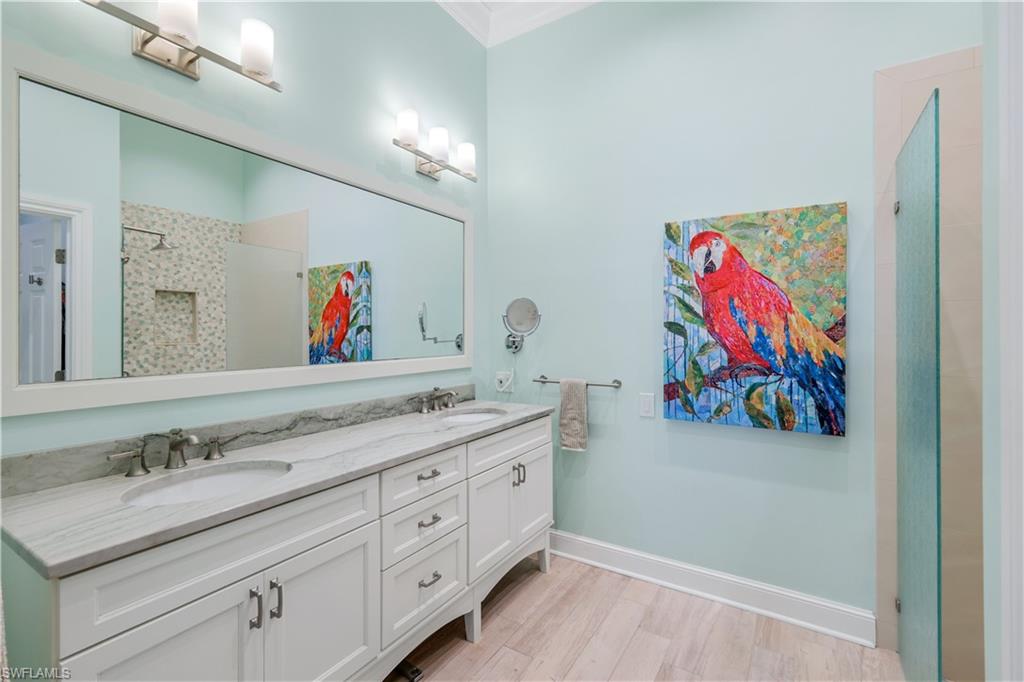 11831 Quail Village Way Naples, FL 34119 - Photo 18 of 32 a bathroom with a sinks a vanity a painting on the wall and a double vanity