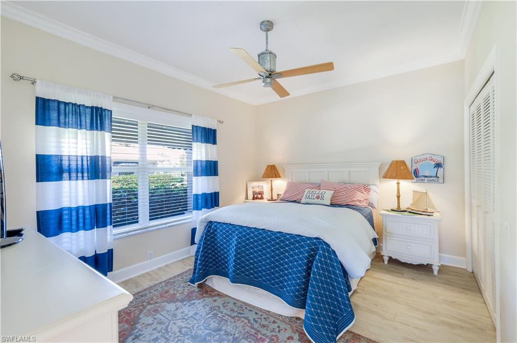 11831 Quail Village Way Naples, FL 34119 - Photo 19 of 32 a bedroom with a bed and window