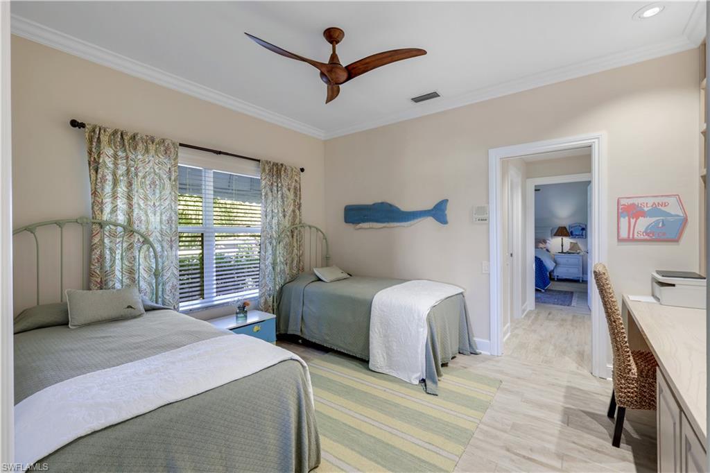 11831 Quail Village Way Naples, FL 34119 - Photo 21 of 32 a bedroom with a bed and a large window