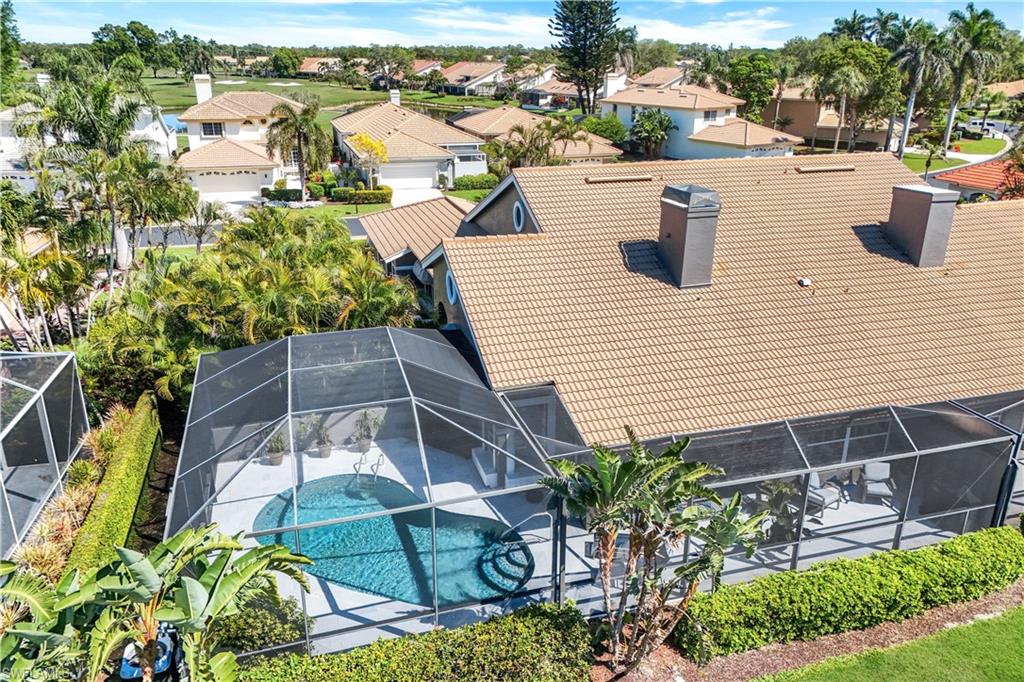 11831 Quail Village Way Naples, FL 34119 - Photo 23 of 32 an aerial view of a house with garden space and plants