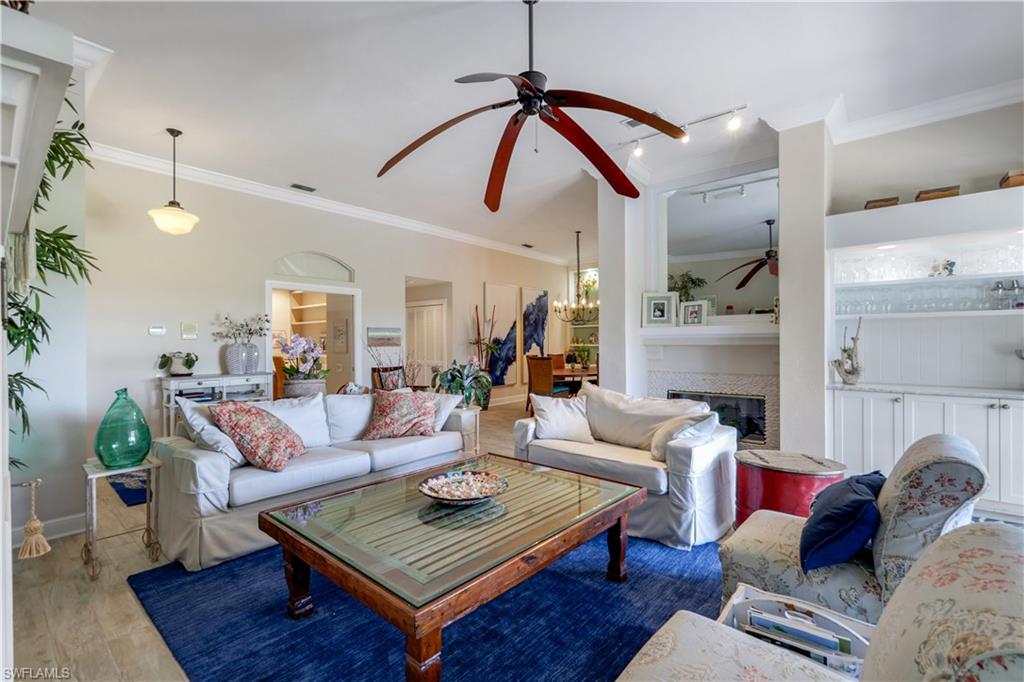 11831 Quail Village Way Naples, FL 34119 - Photo 5 of 32 a living room with furniture and wooden floor