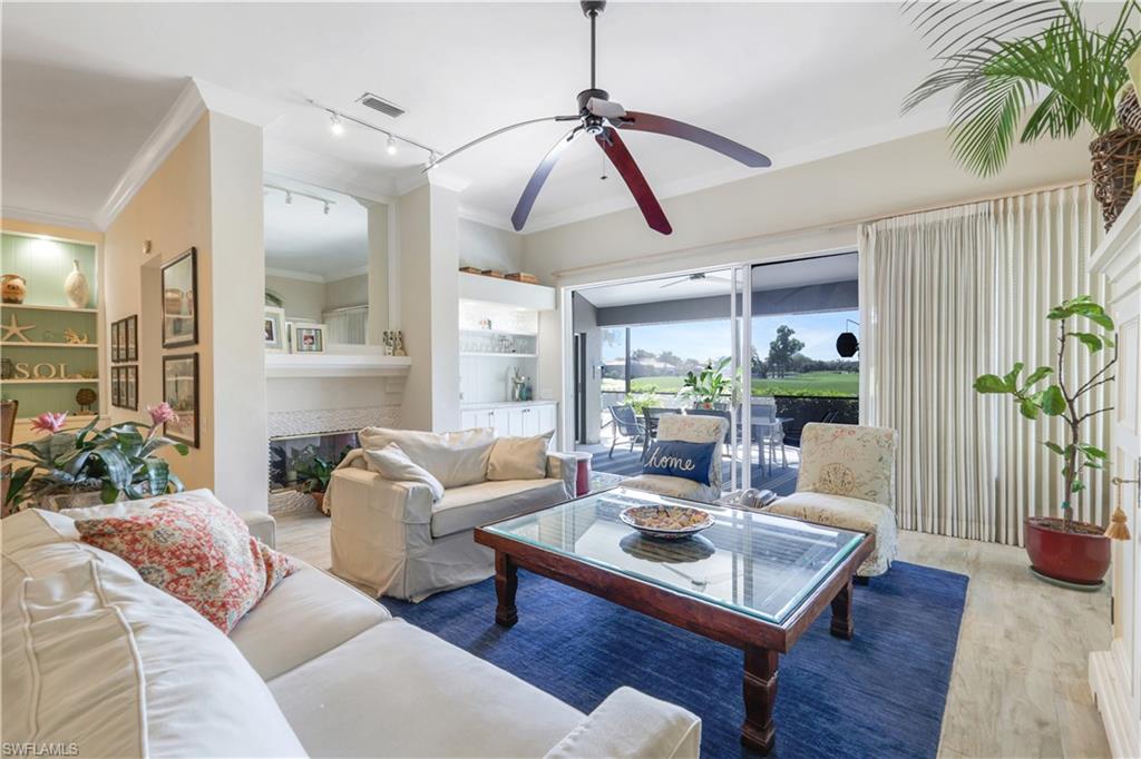 11831 Quail Village Way Naples, FL 34119 - Photo 6 of 32 a living room with furniture and a large window