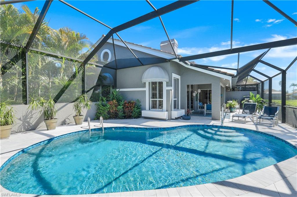 11831 Quail Village Way Naples, FL 34119 - Photo 9 of 32 a view of a house with sitting area and garden