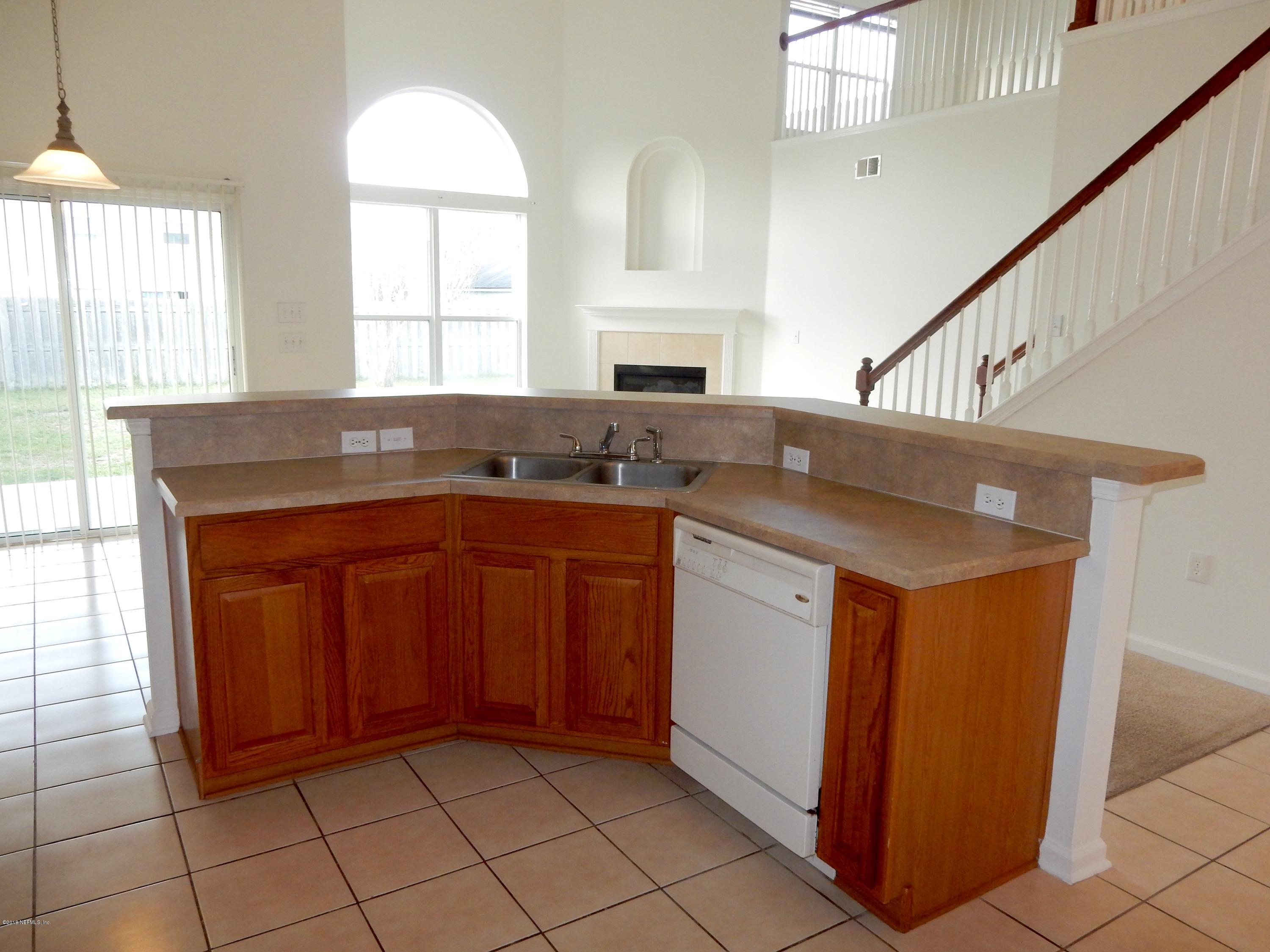 1528 Summerdown Way St. Johns, FL 32259 - Photo 11 of 28 a kitchen with stainless steel appliances granite countertop a sink and a cabinets