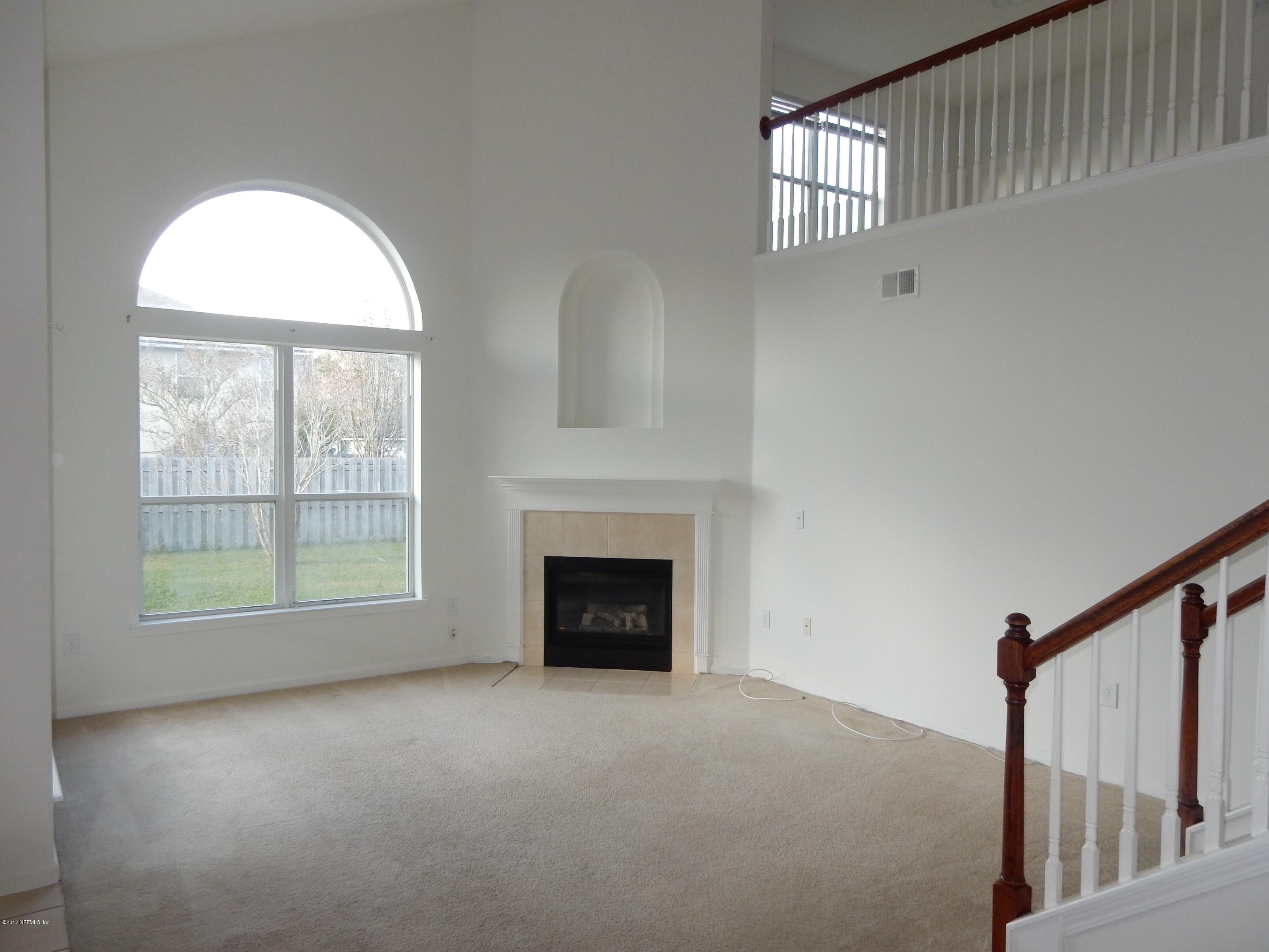 1528 Summerdown Way St. Johns, FL 32259 - Photo 13 of 28 a view of empty room with windows and fireplace