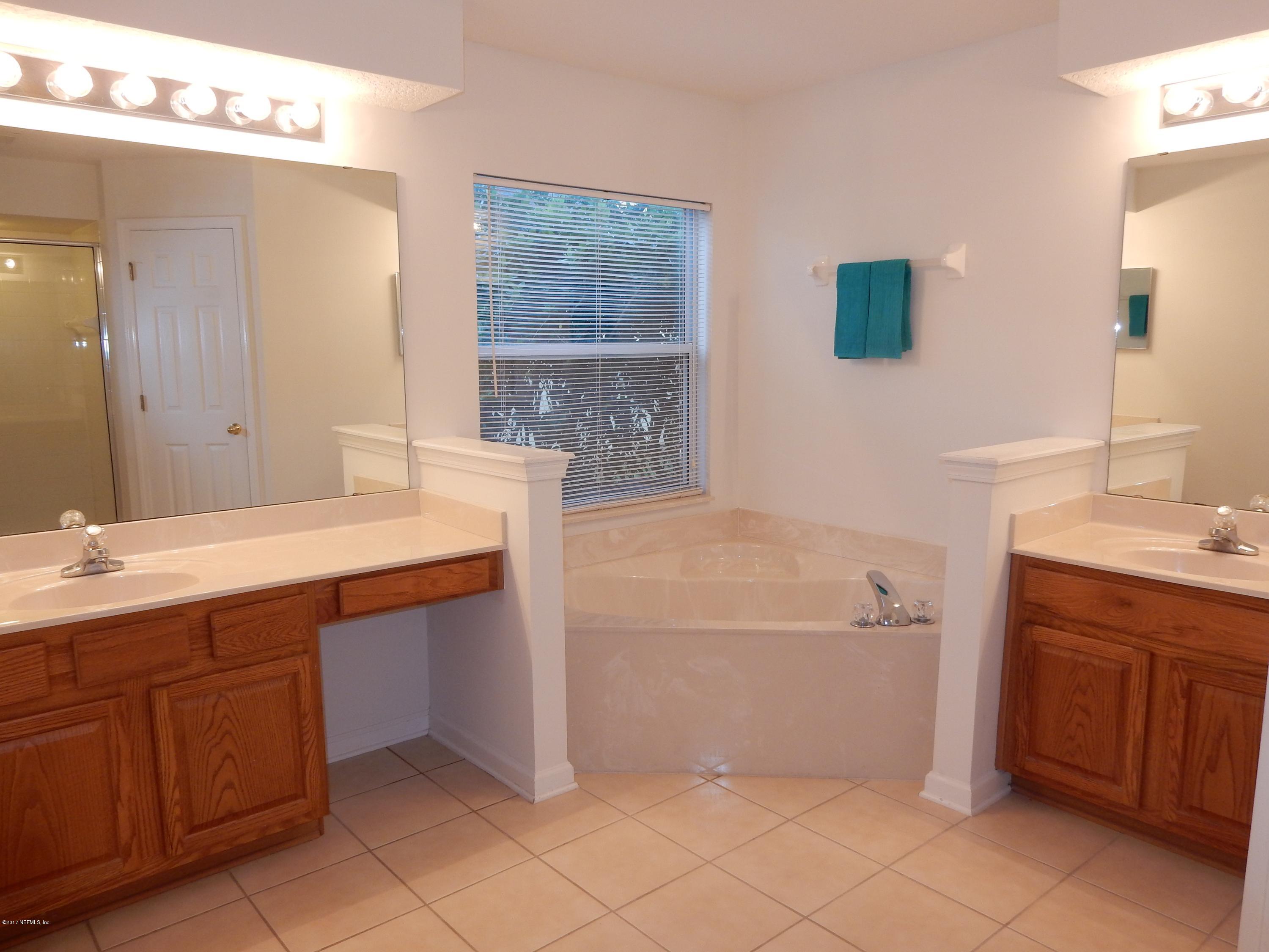 1528 Summerdown Way St. Johns, FL 32259 - Photo 18 of 28 a bathroom with a sink and a mirror
