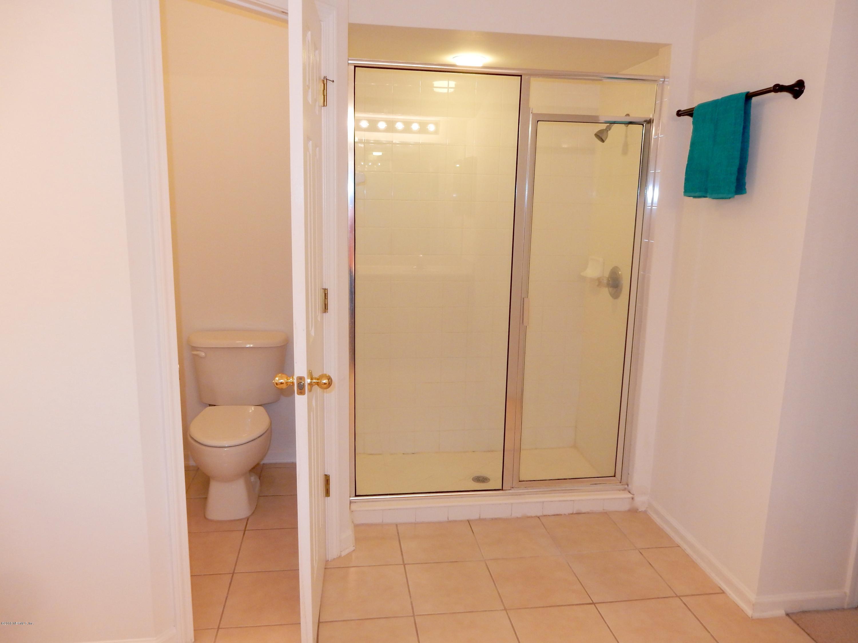 1528 Summerdown Way St. Johns, FL 32259 - Photo 19 of 28 a bathroom with a granite countertop shower and a toilet