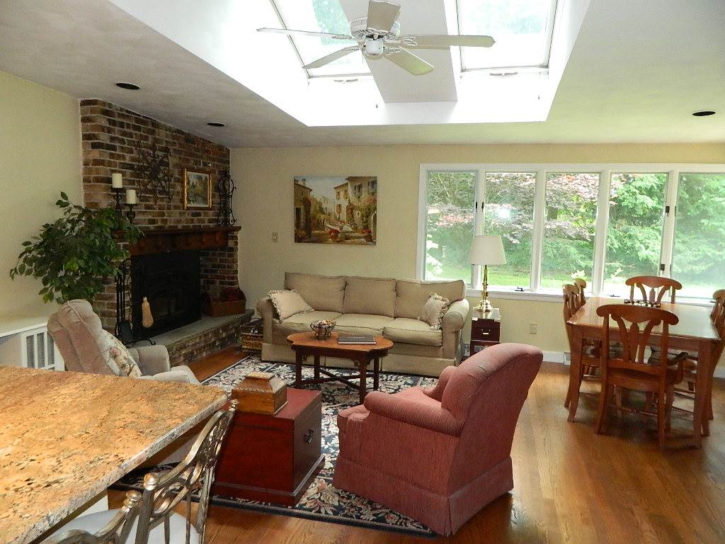 4619 Spring Brook Road Rockford, IL 61114 - Photo 11 of 32 a living room with furniture a fireplace and a large window