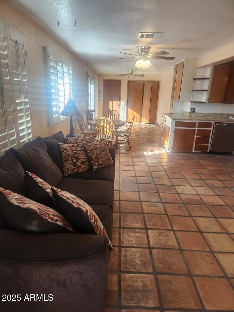 7 East Beautiful Lane Phoenix, AZ 85042 - Photo 22 of 26 a living room with couches and kitchen view with wooden floor