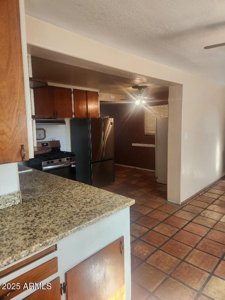 7 East Beautiful Lane Phoenix, AZ 85042 - Photo 24 of 26 a kitchen with stainless steel appliances granite countertop a sink and a refrigerator