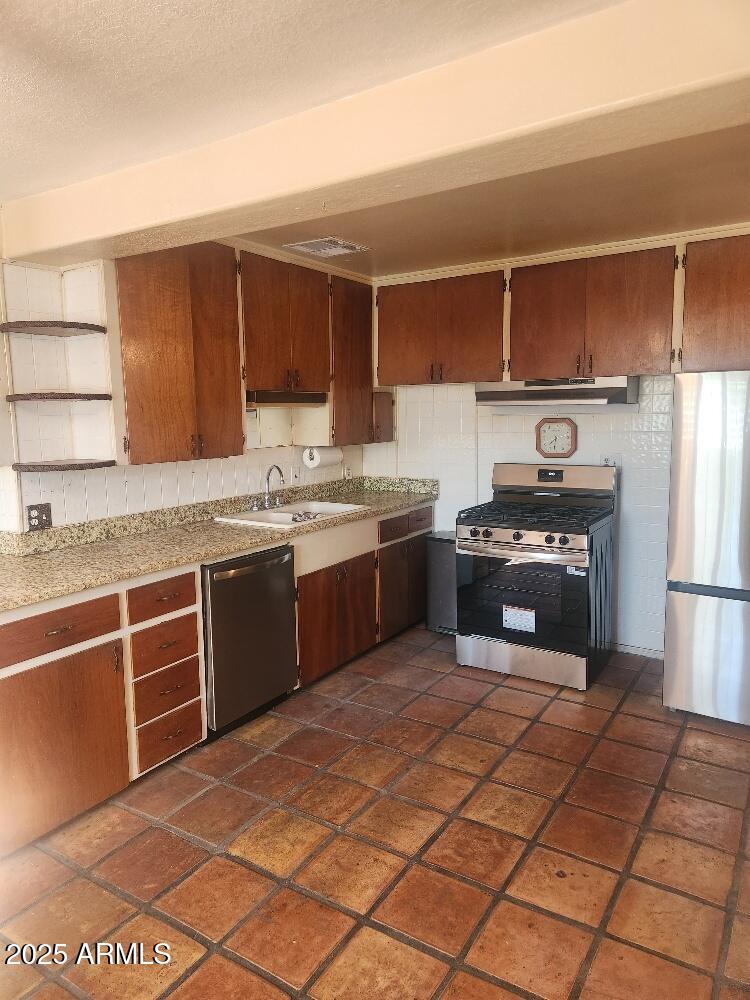 7 East Beautiful Lane Phoenix, AZ 85042 - Photo 26 of 26 a kitchen with stainless steel appliances granite countertop a stove a sink and a refrigerator