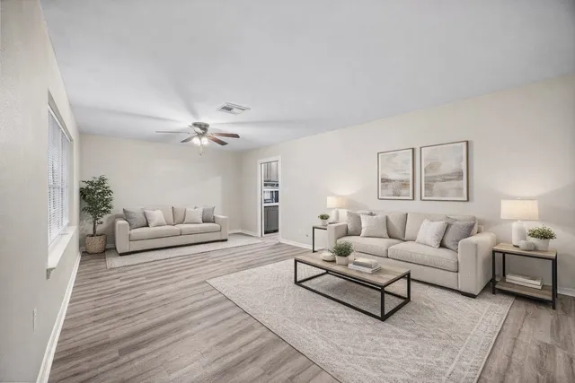 a living room with furniture and a chandelier