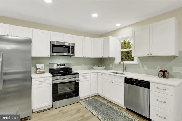 a kitchen with a sink stove and microwave
