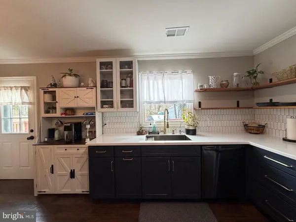 a kitchen with stainless steel appliances granite countertop a sink and cabinets
