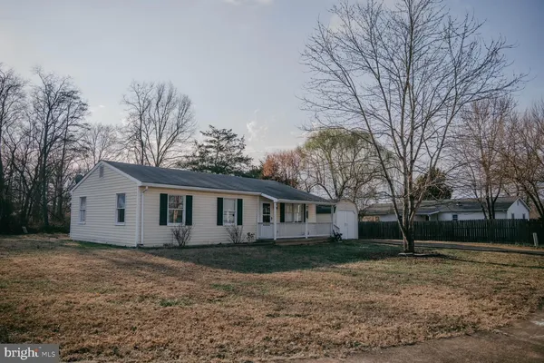 a view of house with a yard