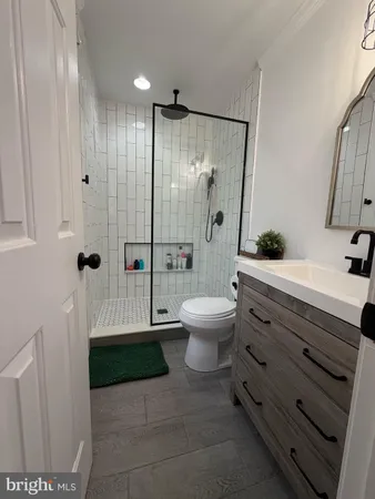 a bathroom with a shower toilet and sink