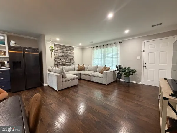 a living room with furniture window and wooden floor