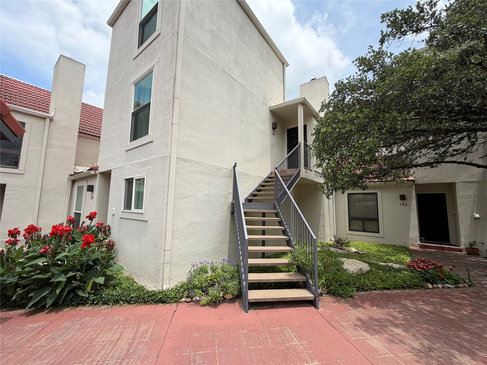 2918 Ranch Road 620 North, Unit C120 Austin, TX 78734 - Photo 1 of 1 The 2-level residence with inviting paved pathways and lush, vibrant landscaping.