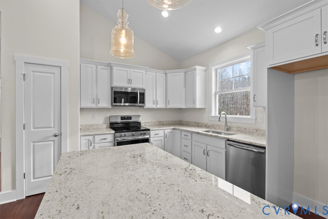 4522 Old Stage Road Freeman, VA 23856 - Photo 17 of 51 a kitchen with granite countertop a stove sink and microwave