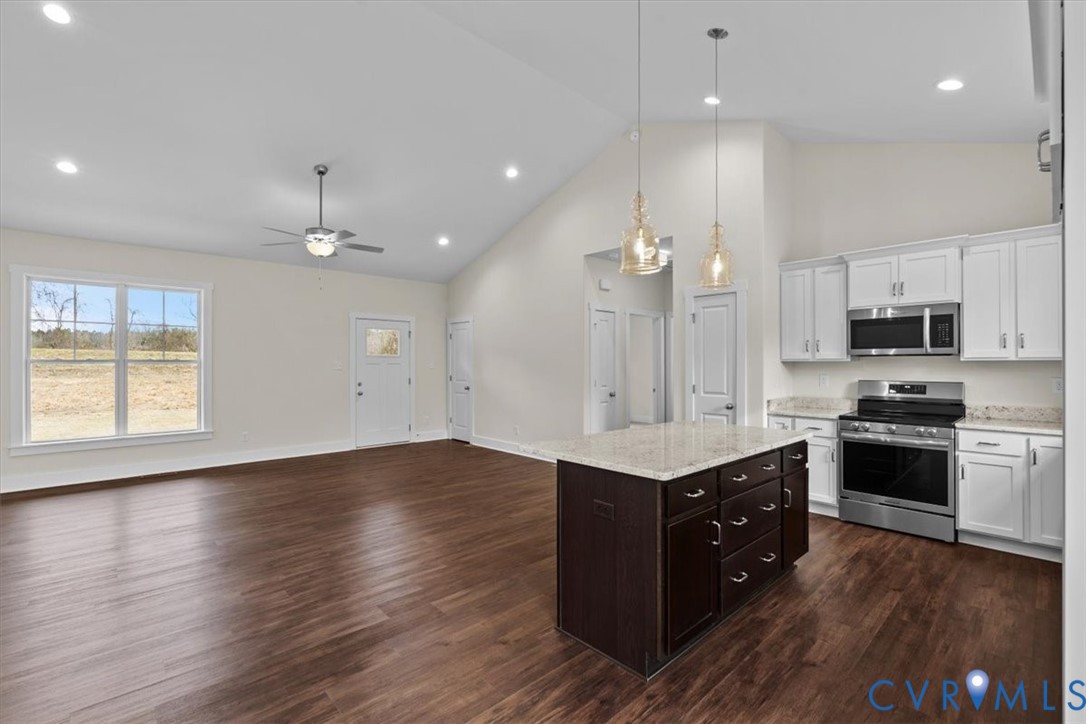 4522 Old Stage Road Freeman, VA 23856 - Photo 18 of 51 a kitchen with stainless steel appliances a stove top oven a sink dishwasher and a refrigerator with wooden floor