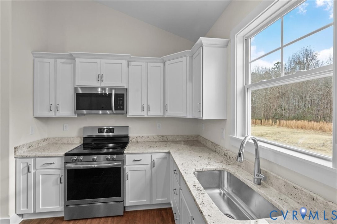 4522 Old Stage Road Freeman, VA 23856 - Photo 21 of 51 a kitchen with stainless steel appliances granite countertop a sink stove and microwave