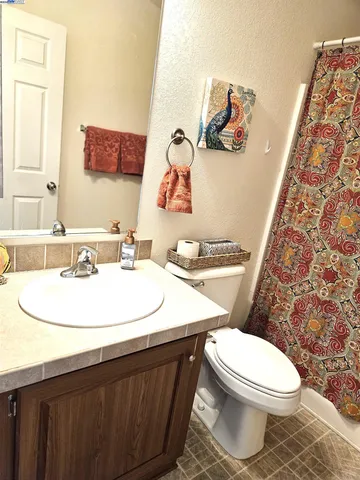 a bathroom with a sink a toilet and mirror