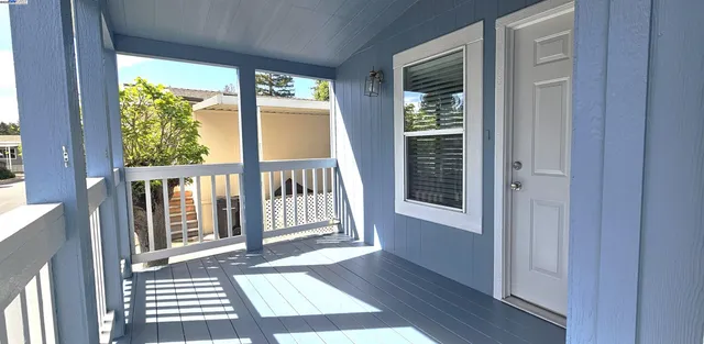 a view of a balcony with wooden floor