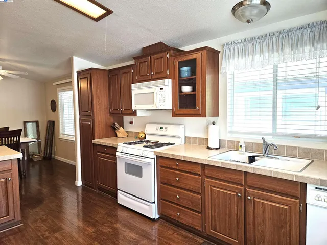 a kitchen with a sink cabinets stainless steel appliances and a window