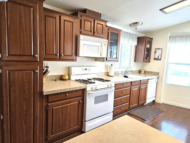 a kitchen with a stove sink and cabinets