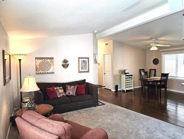 a living room with furniture and wooden floor