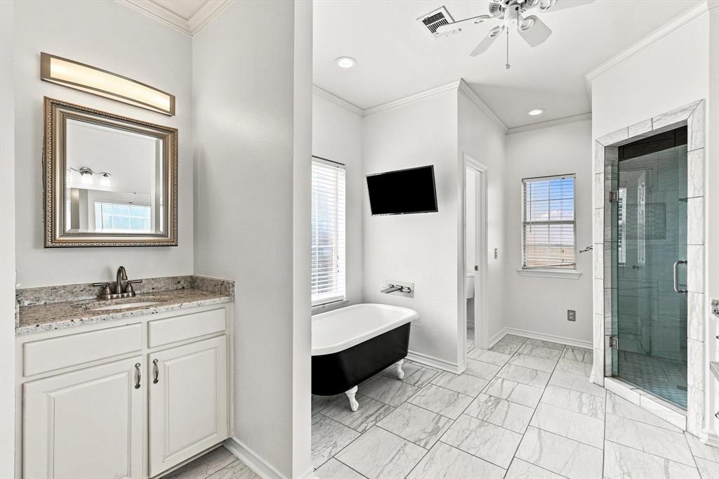 47 Preakness Place Road Van Alstyne, TX 75495 - Photo 16 of 34 No knocking elbows in the spacious primary bath, single vanity shown here, with separate shower and love the latrine area with the door! Soaking tub to relax and enjoy your show.