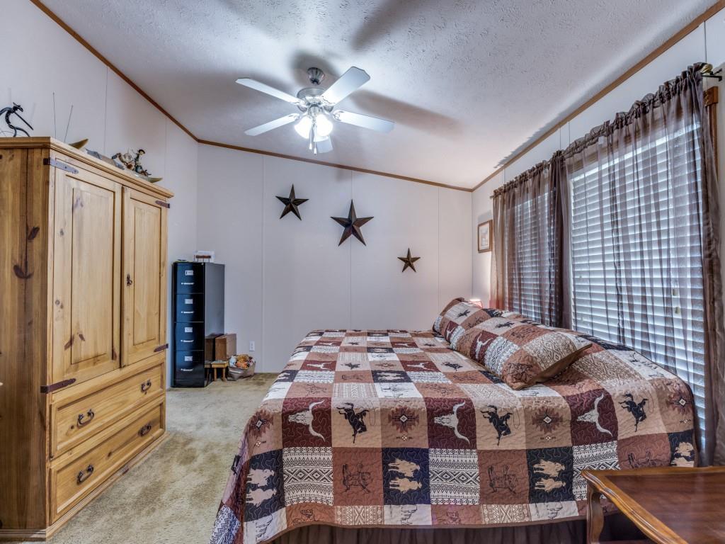 3517 Sandusky Road Whitesboro, TX 76273 - Photo 6 of 19 a bedroom with a bed and a chandelier