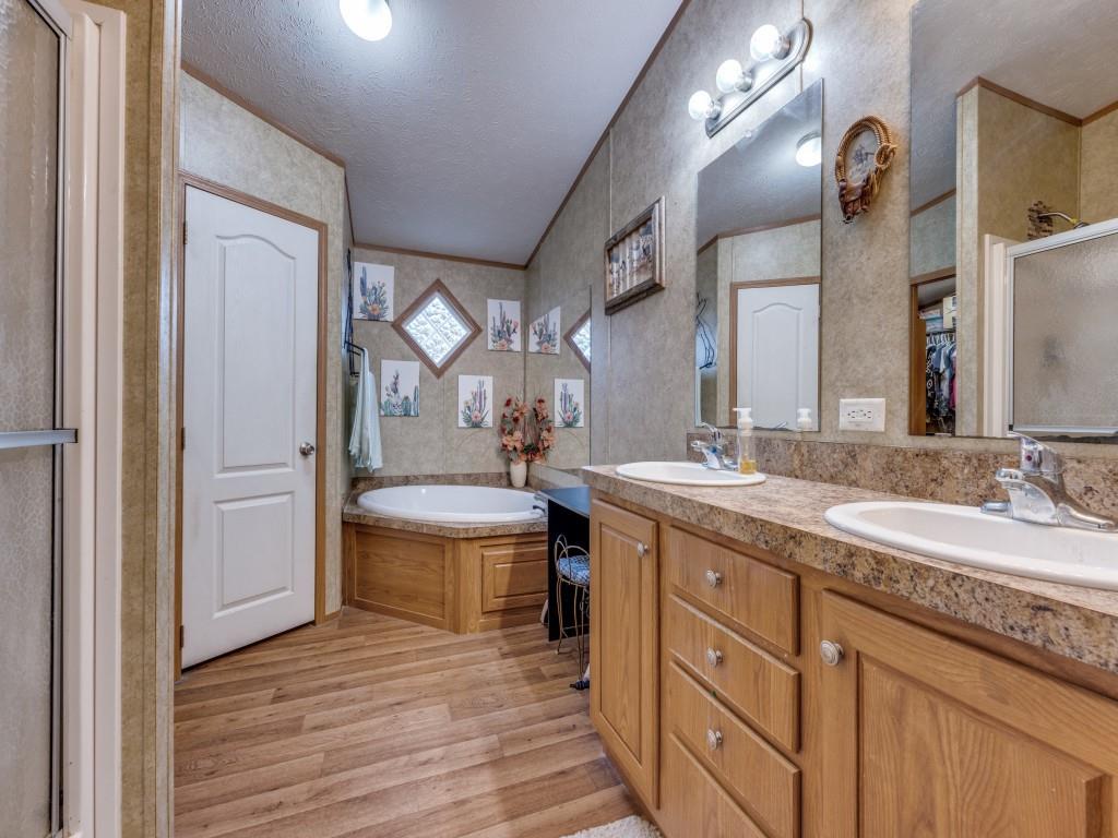 3517 Sandusky Road Whitesboro, TX 76273 - Photo 7 of 19 a bathroom with a double vanity sink and a mirror