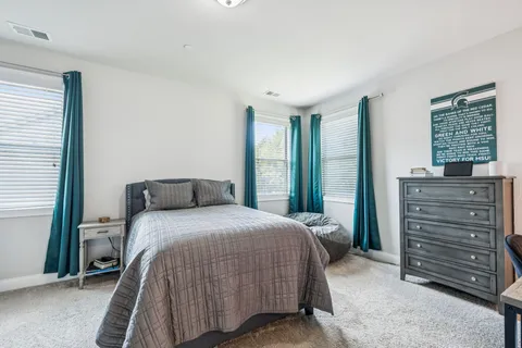 a bedroom with a bed and a couch