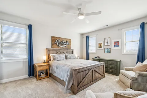 a bedroom with two beds and a desk