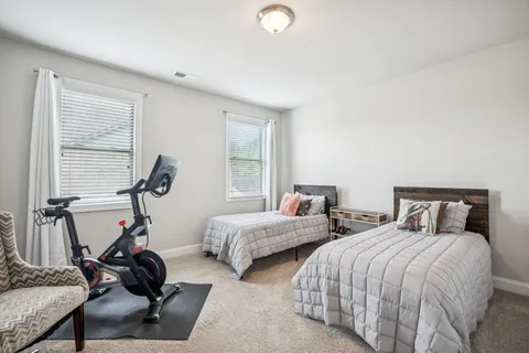 a bed room with a bed and a large window