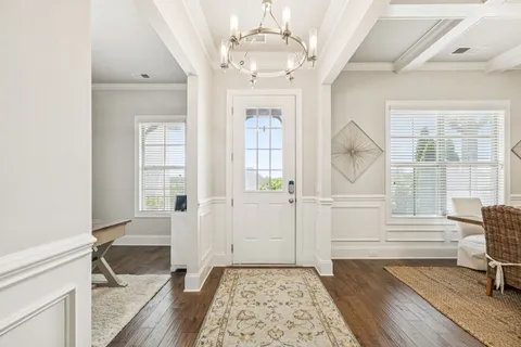 a view of a dining room with furniture and a chandelier