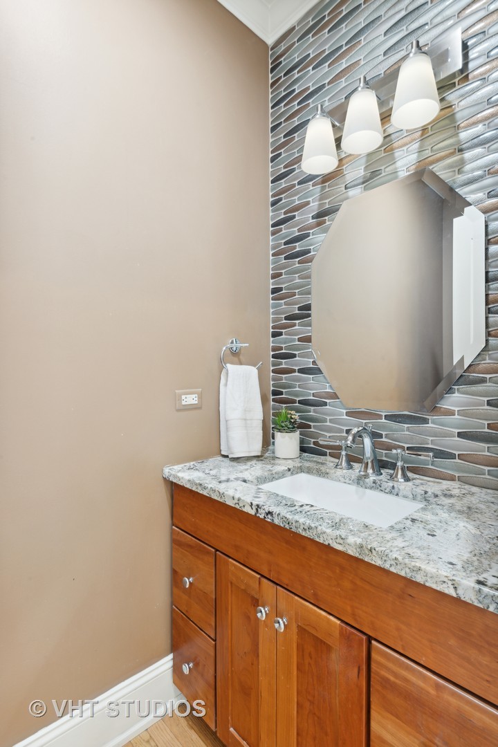 162 Akenside Road Riverside, IL 60546 - Photo 20 of 42 a bathroom with a granite countertop sink and mirror
