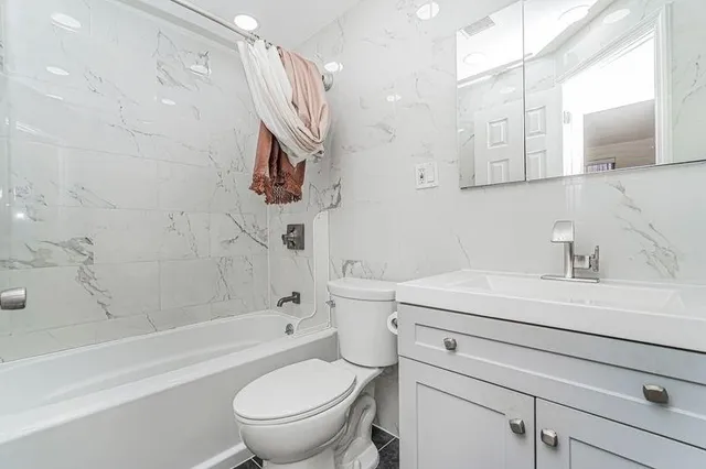 a bathroom with a sink a toilet and a bathtub